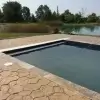 Stamped random stone concrete surrounding pool